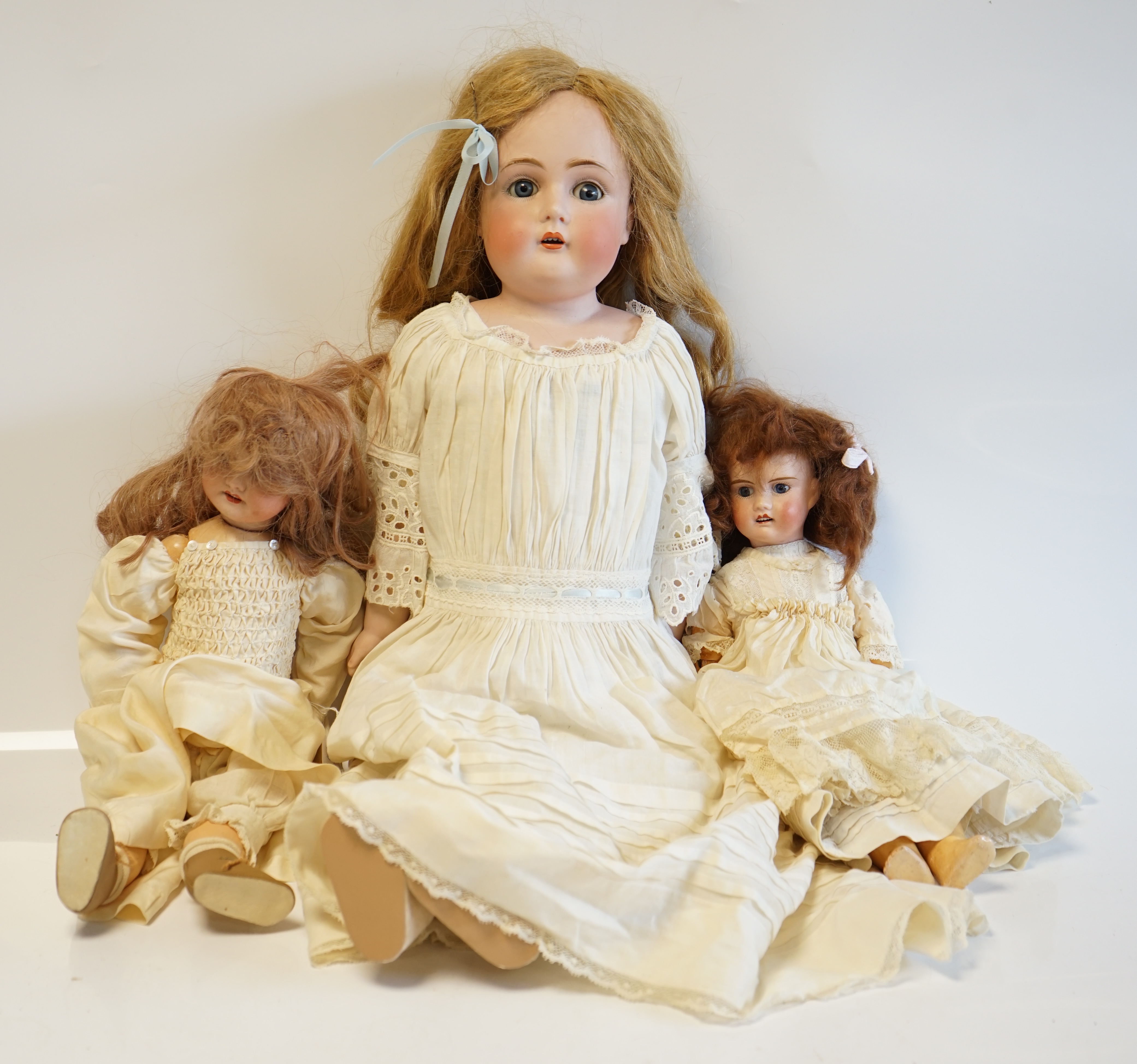 A German bisque shoulder plate doll marked bb on kid body, 60cm high, together with an SFBJ60, 42cm, and a Unis France, 36cm high (3). Condition - good